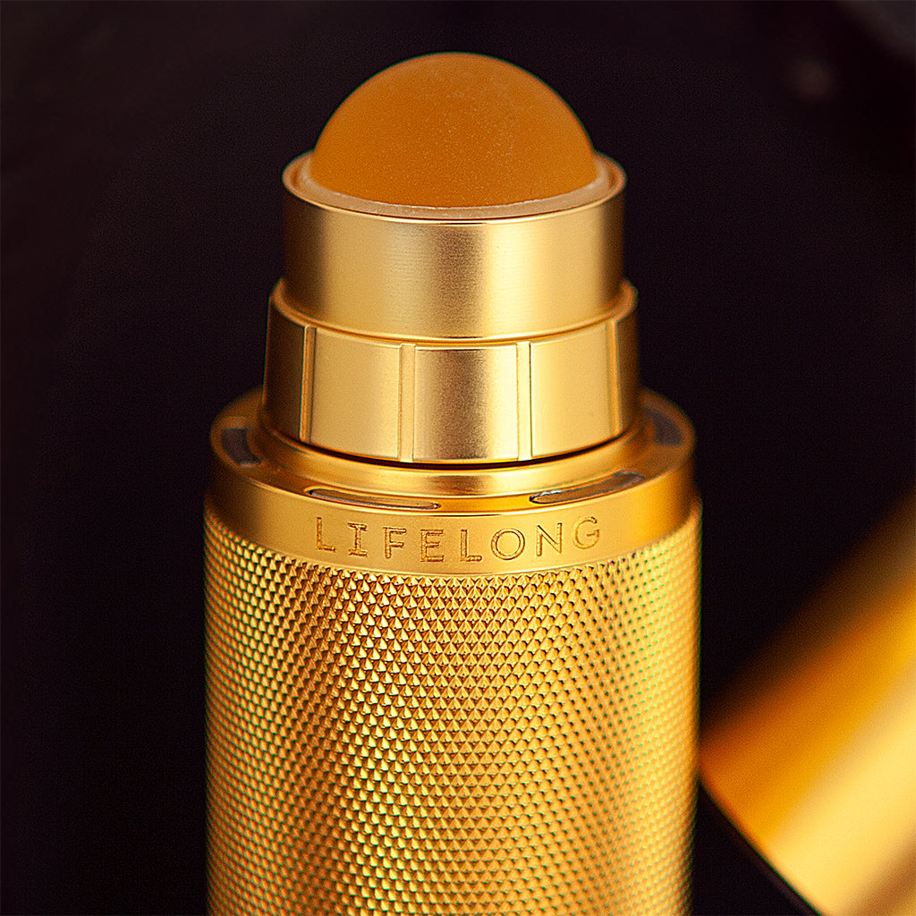 24 carat Gold plate Refillable roll-on deodorant. Lid is off showing the roll-on. Design, knurled texture and debossed Lifelong logo .